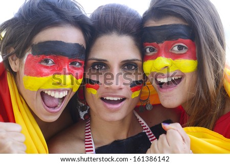 Group of happy german soccer fans commemorating victory yelling.