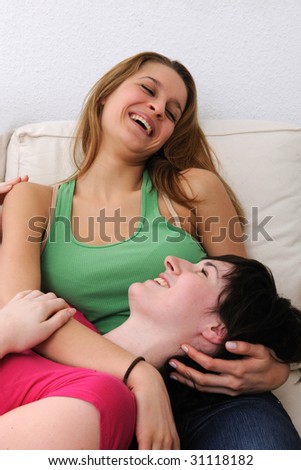 two happy girls laughing cheerful at home