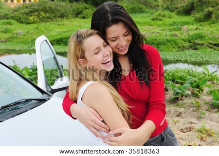 two happy women on car trip