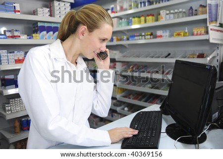 pharmacist using computer and telephone