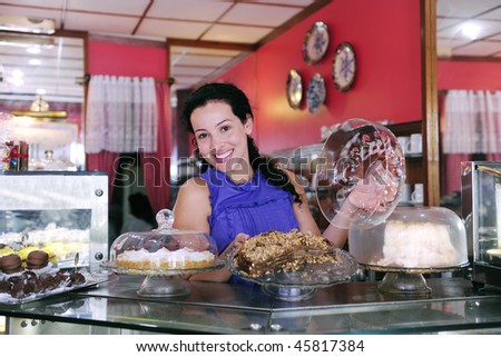 owner of a small business store showing her tasty cakes