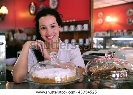 stock photo owner of a small business store showing her tasty cakes