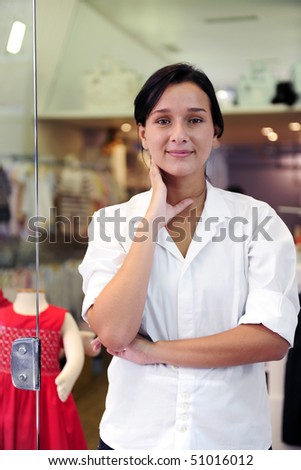 portait of small business owner: proud woman opening her children clothing shop