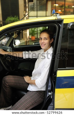porait of a proud female taxi driver with her new cab
