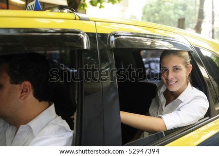 urban transport: happy female passenger inside of a taxi