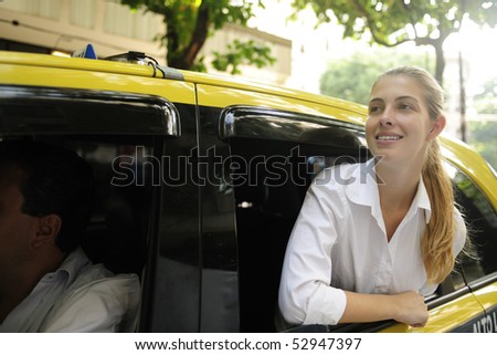urban transport: happy female passenger inside of a taxi