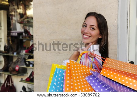 summer sale: woman with shopping bags in front of a store