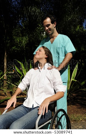 shoulder massage: healthcare worker and  woman in a wheelchair