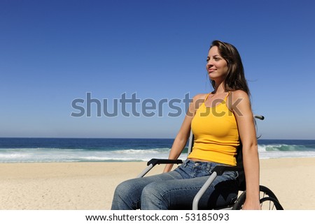 summer vacation: woman in wheelchair  enjoying outdoors beach
