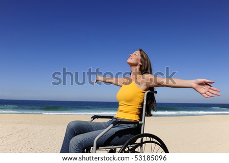 summer vacation: woman in wheelchair  sunbathing outdoors beach