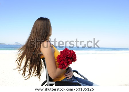 romance: woman in wheelchair with red roses