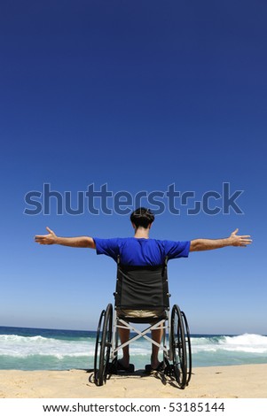 summer vacation: man in wheelchair enjoying outdoors beach