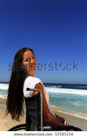summer vacation: woman in wheelchair enjoying outdoors beach