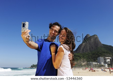 tourist couple in Rio de Janeiro taking a photo with a digital compact camera tourist couple in Rio de Janeiro taking a photo with a digital compact camera