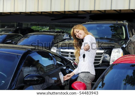 stock photo happy woman showing key of new sports car