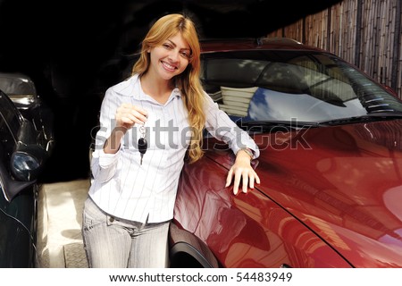 stock photo happy woman showing key of new red sports car