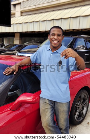 stock photo happy man showing key of new red sports car