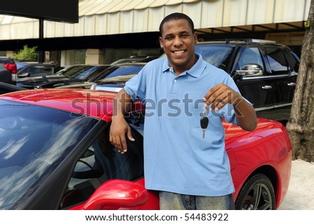 stock photo happy man showing key of new red sports car