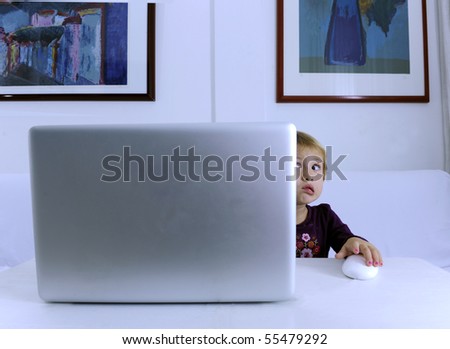 nerd child alone scared with a virus problem on laptop computer surfing the Internet