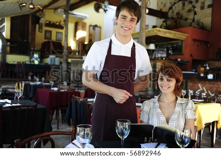 waiter and happy costumer at the restaurant with copy space