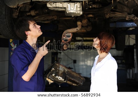car mechanic talking to costumer at the car  repair  shop