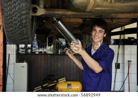 happy car mechanic working at the car  repair  shop
