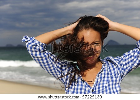 stormy wind: wind blowing young woman?s hair by the sea