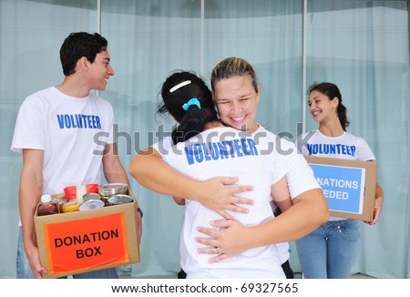 happy volunteer group with food donation boxes