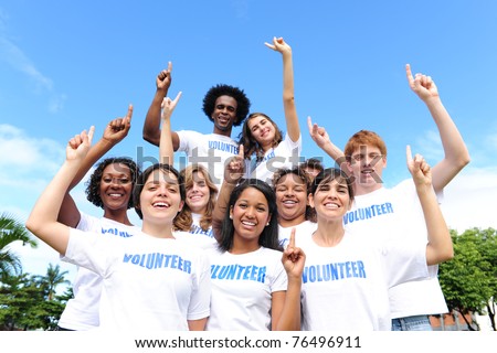 portrait of a happy and diverse volunteer group hands raised