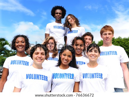 happy multi-ethnic volunteer group outdoors