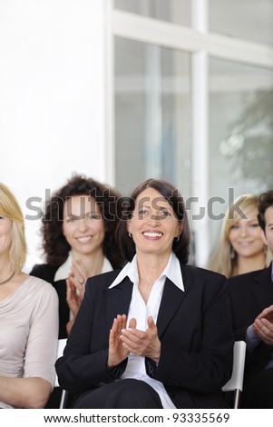 Business team applauding after a conference in a company