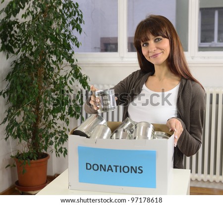 happy volunteer woman with food donation box
