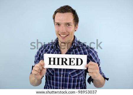 happy young man holding hired sign