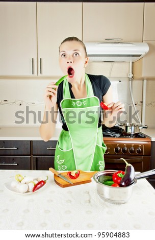 young woman cooks dinner in the kitchen