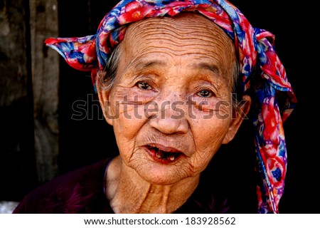 MY SON, VIETNAM - FEBRUARY 02 2007: Elderly woman during Tet Holiday New Year Period at My Son Sanctuary in Vietnam.