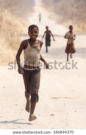 CHOBE, BOTSWANA - OCTOBER 5 2013: Poor African children wander through the desert Chobe National Park. This year was declared as a drought year by the government in Botswana, Africa