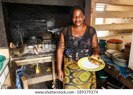 KATIMA MULILO, NAMIBIA - OCTOBER 16 2013: Woman cooks authentic fish dish in food market during a year of drought in the North Eastern town of Katima Mulilo in Namibia, Africa