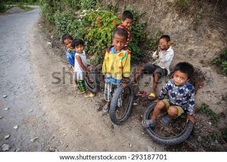 CHIN STATE, MYANMAR - JUNE 16 2015: Children play in the street of a village in the recently opened to foreigners area of Chin State - western Myanmar (Burma)