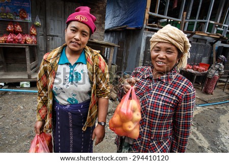 CHIN STATE, MYANMAR - JUNE 23 2015: Ladies selling apples in the recently opened to foreigners area of Chin State - western Myanmar (Burma)