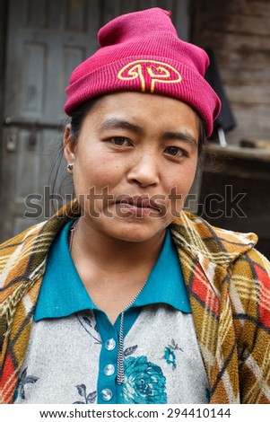 CHIN STATE, MYANMAR - JUNE 23 2015: Friendly lady in village popular for selling apples in the recently opened to foreigners area of Chin State - western Myanmar (Burma)