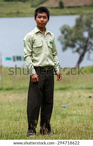 RHI, MYANMAR - JUNE 22 2015: Government Administration Official man wears smart green uniform in the recently opened region of Chin State in Western Myanmar (Burma)