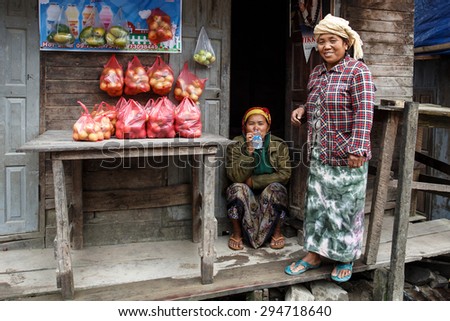 CHIN STATE, MYANMAR - JUNE 23 2015: Ladies selling apples in the recently opened to foreigners area of Chin State - western Myanmar (Burma)