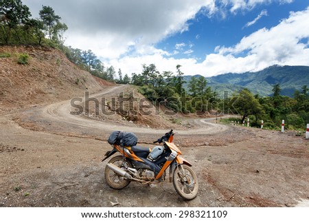 FALAM, MYANMAR - JUNE 22 2015: Motorbike on dirt road in the recently opened to foreigners area of Chin State - western Myanmar (Burma)