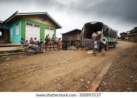 CHIN STATE, MYANMAR - JUNE 22 2015: Transporting goods through a village in the only recently opened for tourists Chin State Mountainous Region, Myanmar (Burma)