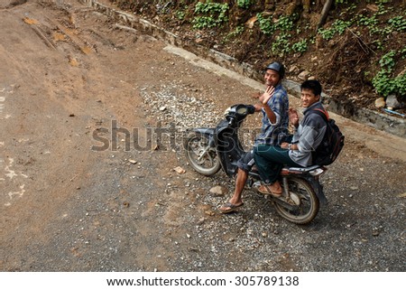 CHIN STATE, MYANMAR - JUNE 18, 2015: Riding motorbike in the recently opened for tourists Chin State Mountainous Region, Myanmar (Burma)