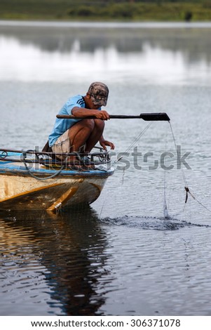 RHI LAKE, MYANMAR - JUNE 21 2015: Local fisherman on the daily fishing trip at the start of the monsoon season in the recently opened to tourists Chin State region of Western Myanmar (Burma)