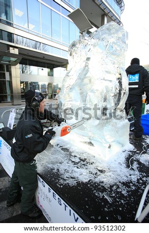 LONDON, UK - JANUARY 13 : Man cuts through ice sculpture with a  chainsaw at the International Ice Sculpting Festival  in London on January 13th, 2012