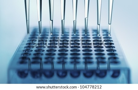 pipette dispensing samples in a deep well plate