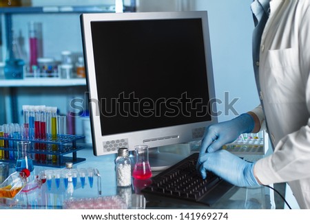 Scientist working at lab with computer
