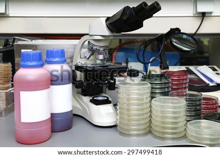 Laboratory workbench with a microscope, plates and reagents for microscopic analysis / lab bench for microscopic analysis